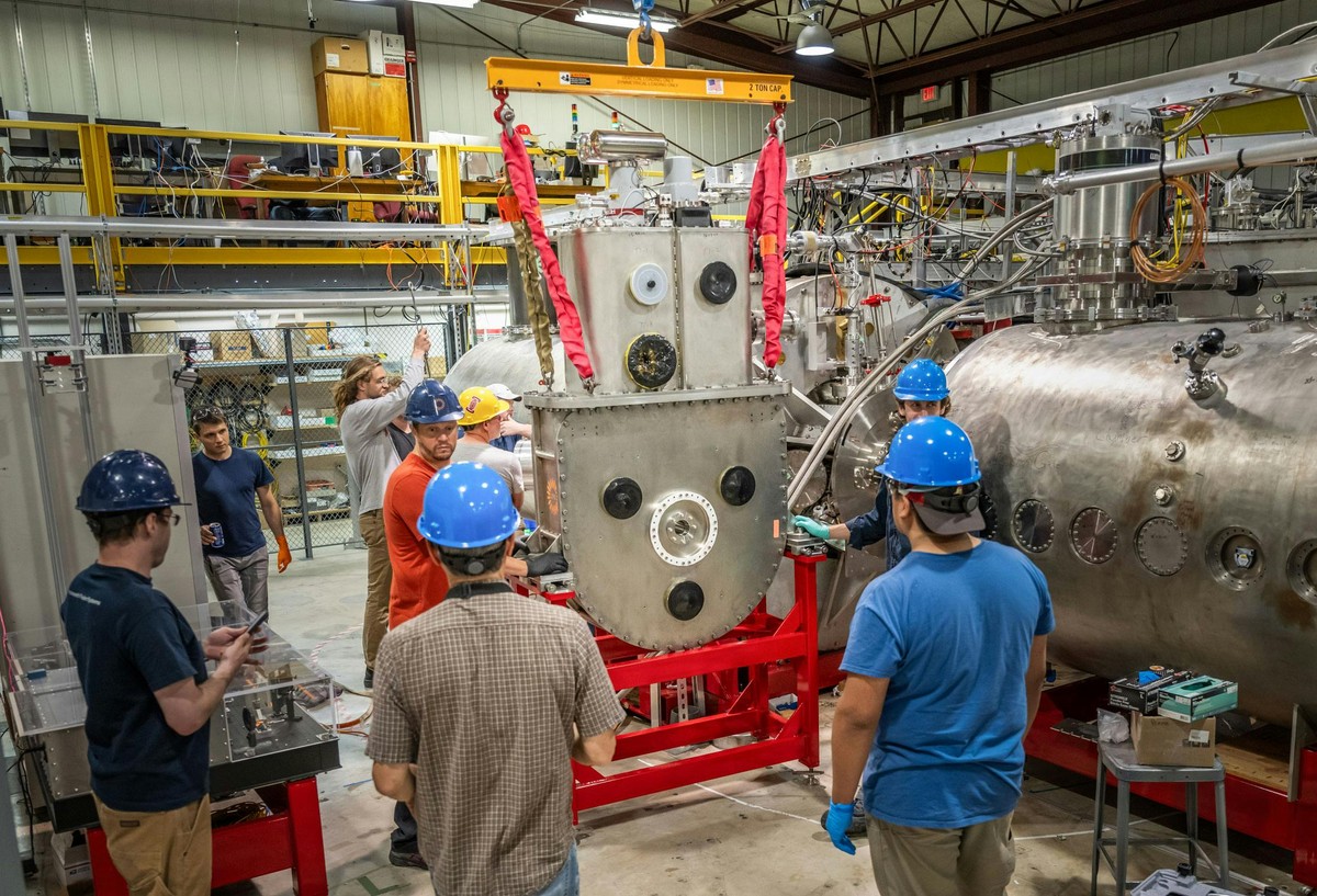 Group gathers around Commonwealth Fusion Systems high-temperature superconducting (HTS) magnet (Thing 1) as it is loaded into WHAM, a mirror fusion device at the University of Wisconsin-Madison.