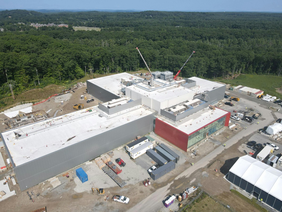 An aerial view of the plus-shaped building that houses the SPARC tokamak, a fusion machine built by Commonwealth Fusion Systems